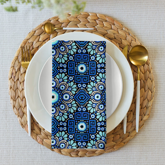 Blue mati mandala cloth napkin from the Asteri × Simply Sim Artistry collaboration styled on an elegant Mediterranean dinner table.